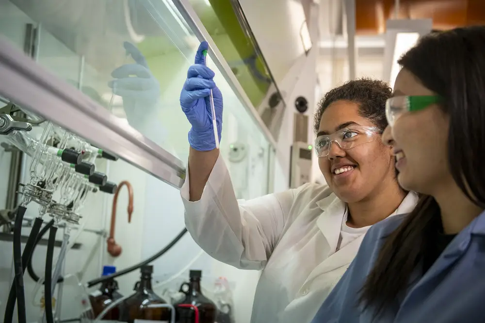 Students smiling while working in the chemistry lab