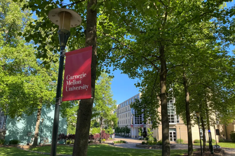 Campus outside in the spring with Carnegie Mellon Banner in view