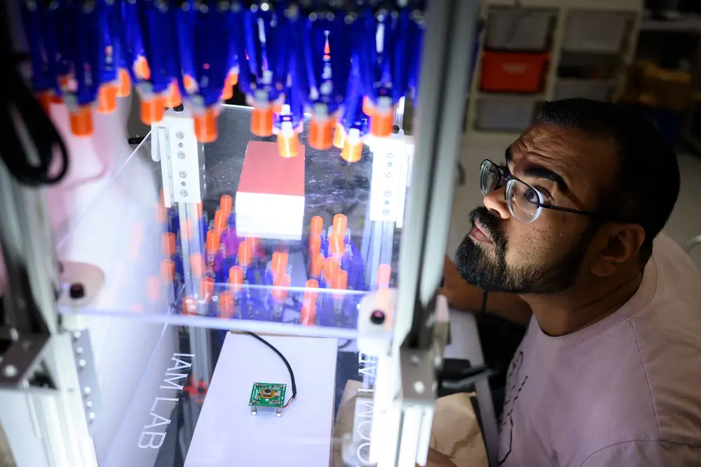 student using machinery in Carnegie Mellon robotics lab