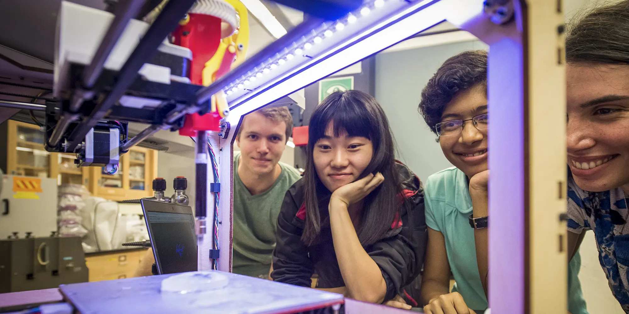 Students watching 3D printer run