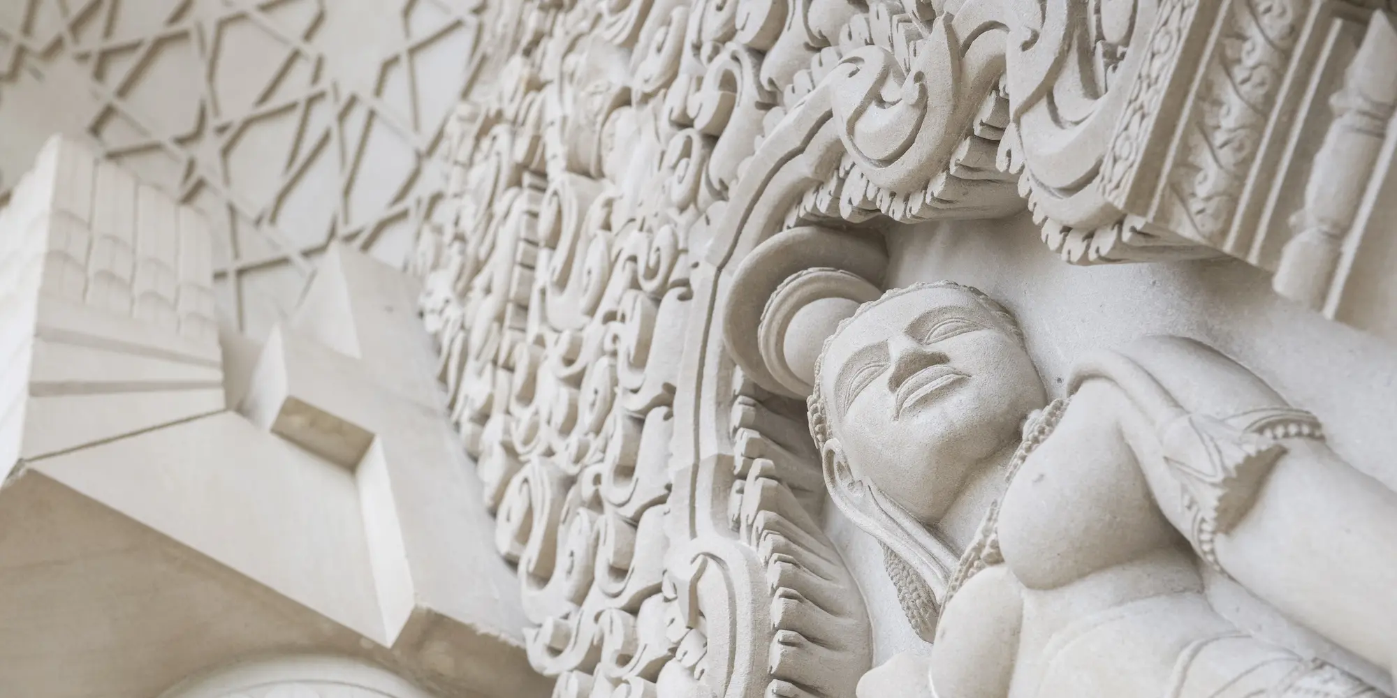 Looking up at a detail of the College of Fine Arts building niches.