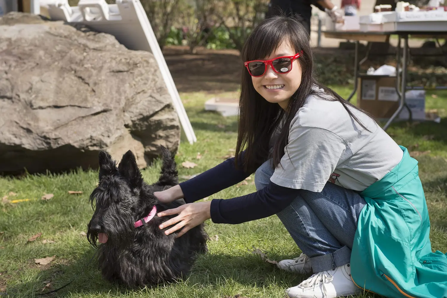 student petting a Scottish Terrier