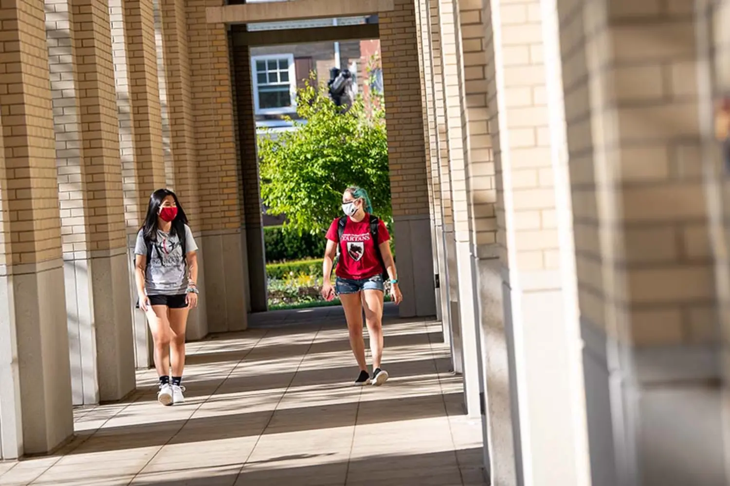 CMU students walking on campus with masks