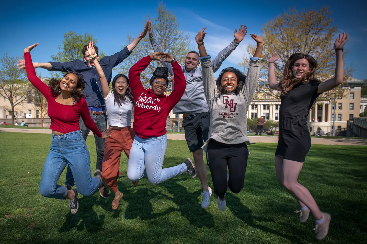 Students Jumping in the Air Outside