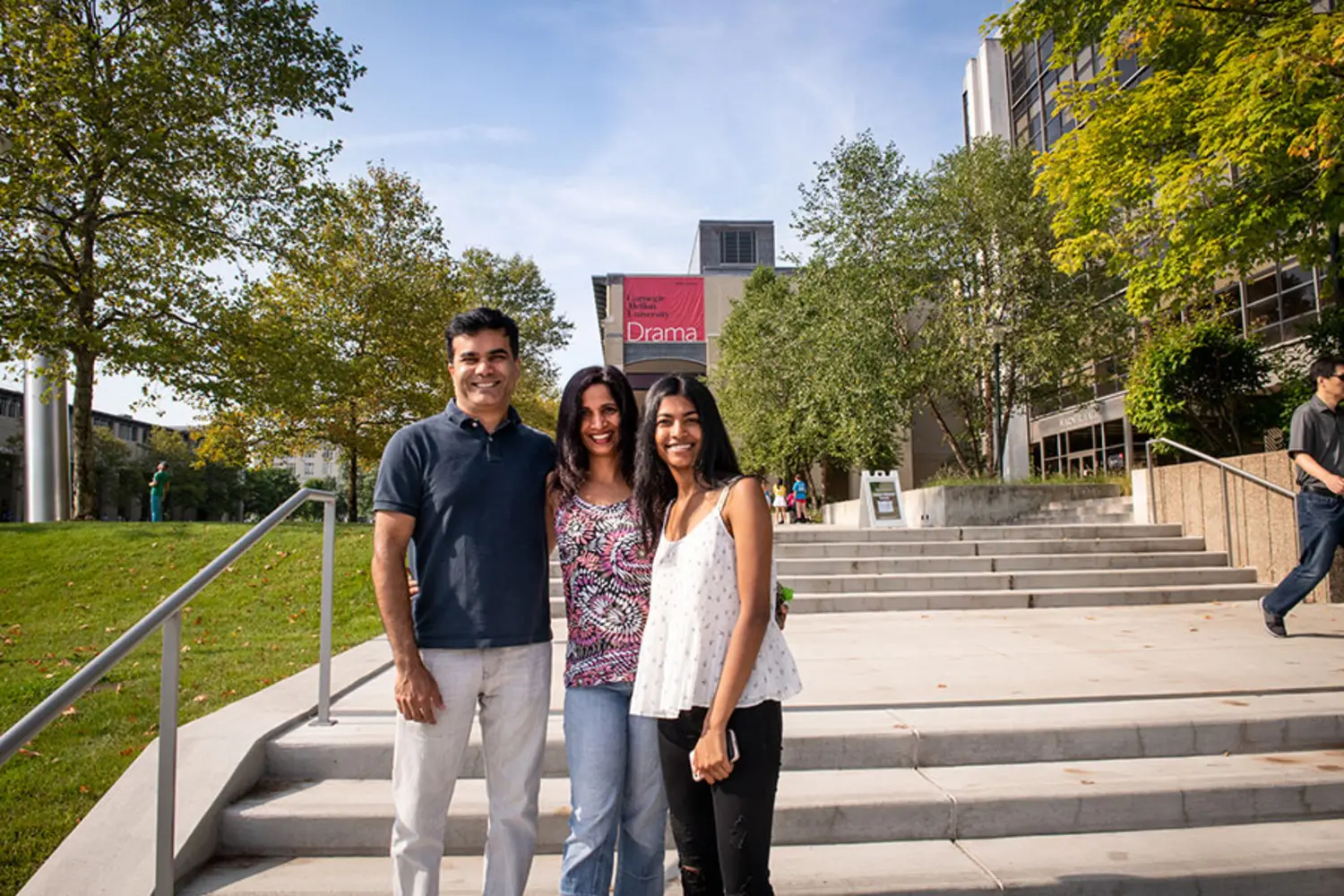 A family, standing together on campus.