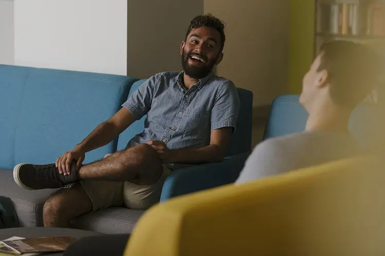 Two individuals talking inside on CMU's campus