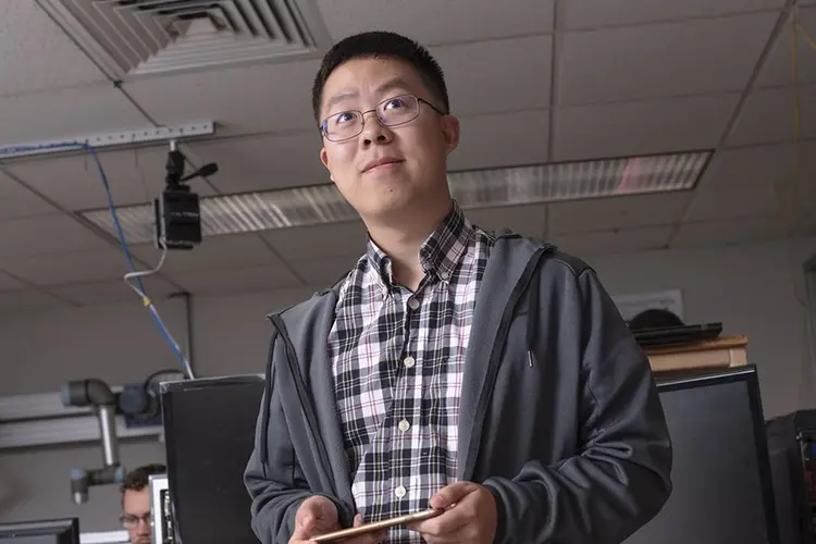 A CMU student looking forward in a computer lab on campus