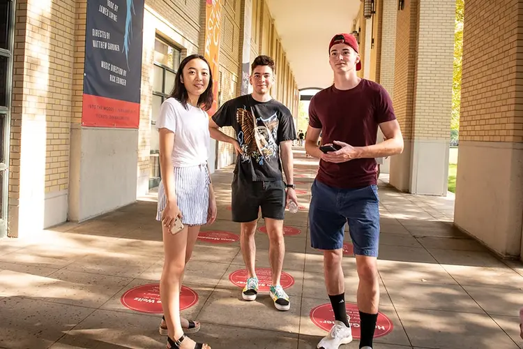 Three CMU students outside on campus at the President's Welcome event