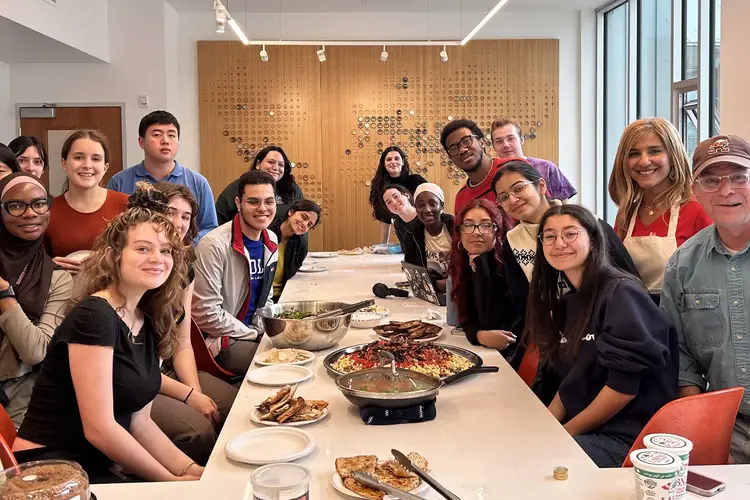 Carnegie Mellon's Nevine Abraham (at right, in white apron) and the students in her course prepare Arab and Mizrahi dishes for Friendsgiving.