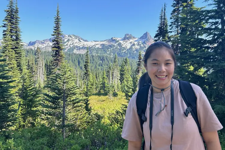 Student posing in front of mountains