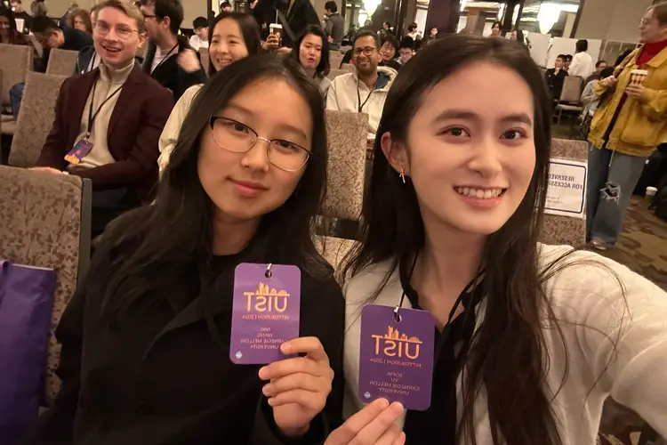 Sofia and a peer at the UIST symposium.