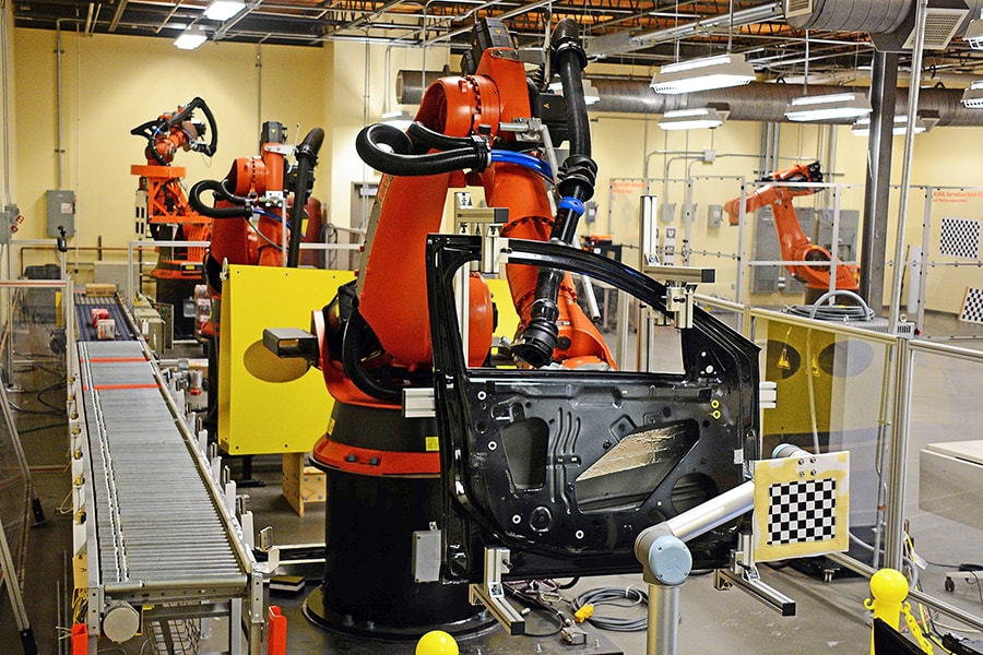 advanced robot arm working along an assembly line