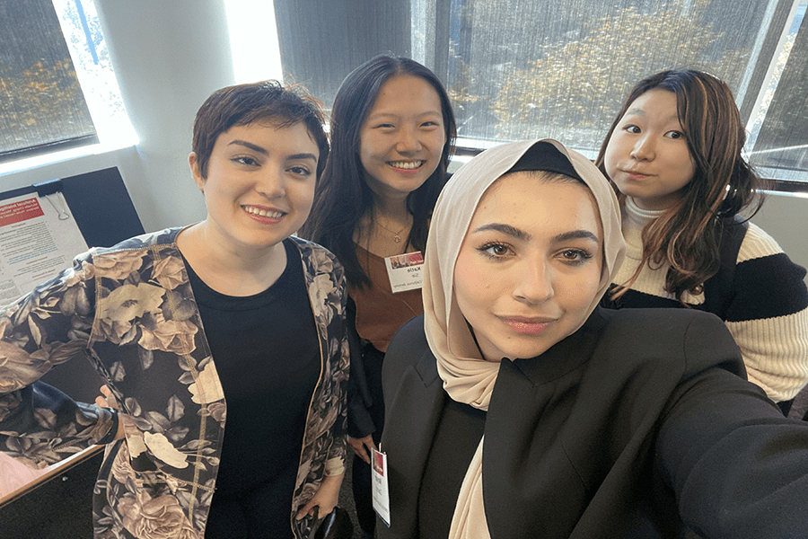 Hoda Heidari works with students during an OurCS event.