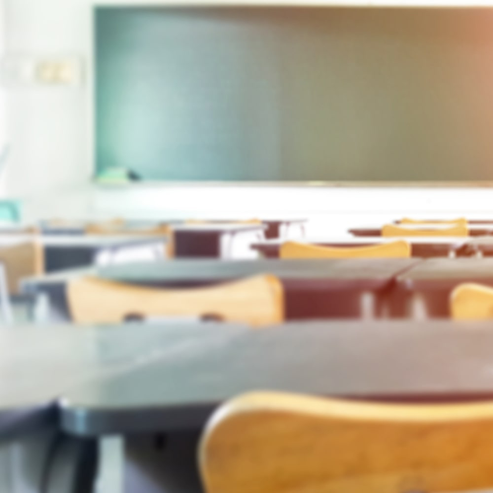 view of front of classroom from behind desks and chairs
