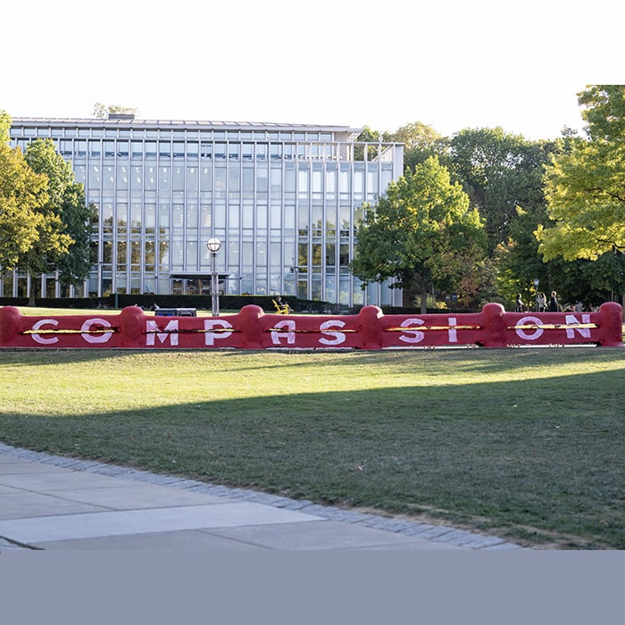 The CMU Fence painted with the word "Compassion"