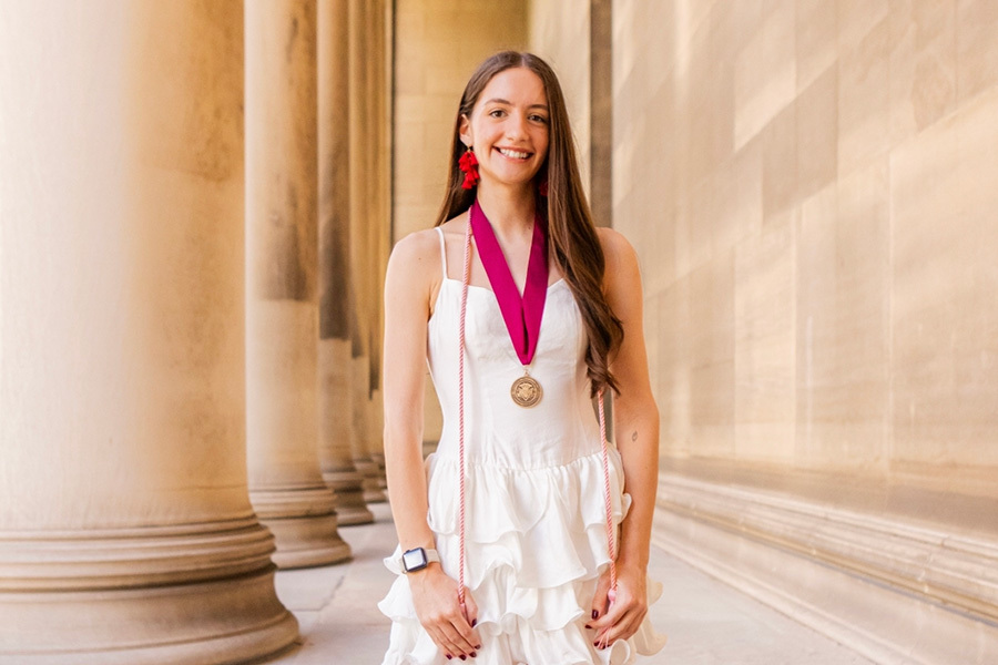 Grace Benkart wears a medal as she stands outside of Mellon Institute.
