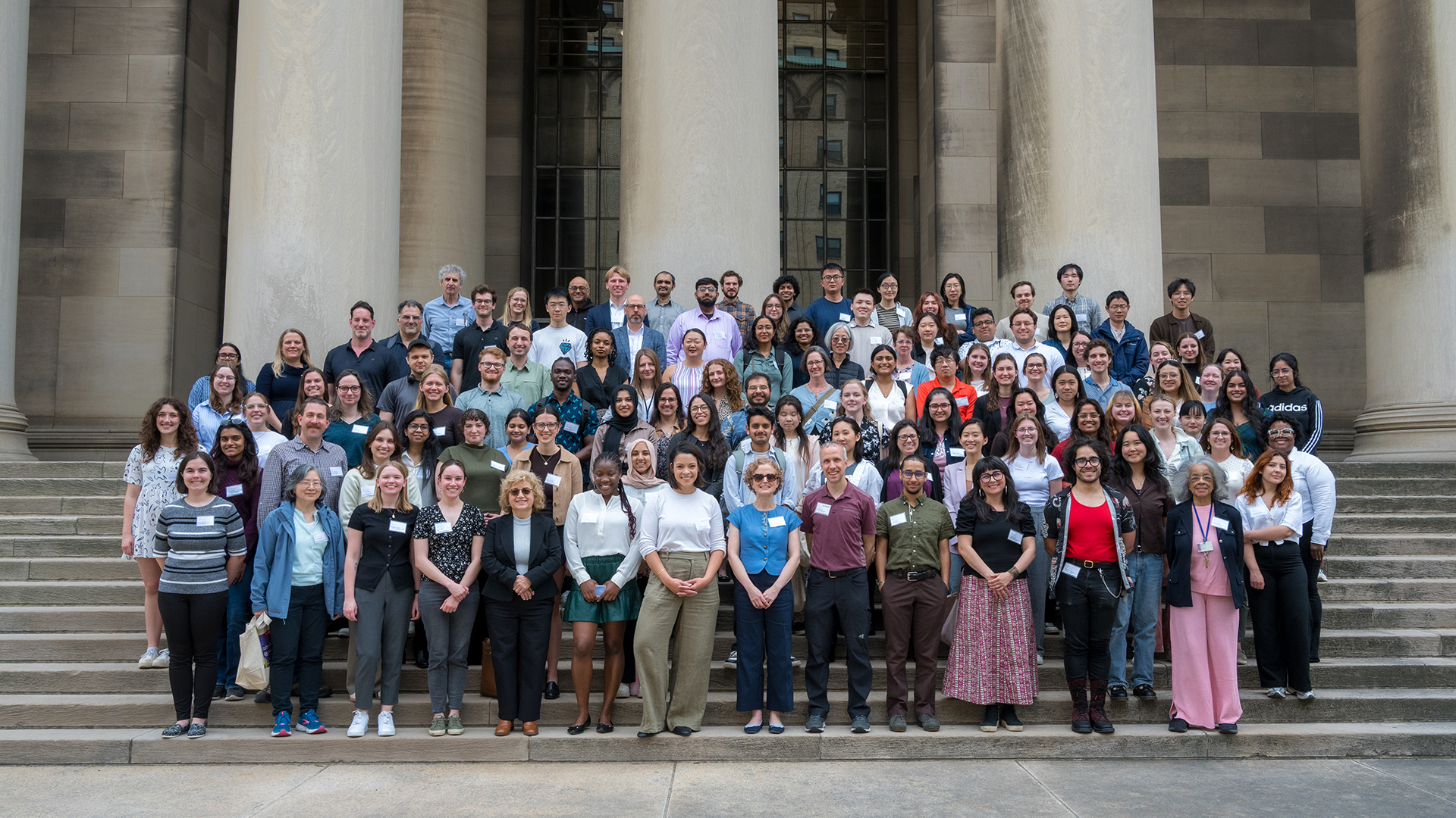 Pittcell Conference participants posing for a group photo on the steps in front of the Mellon Institute.