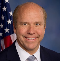 John Delaney headshot with American flag in background