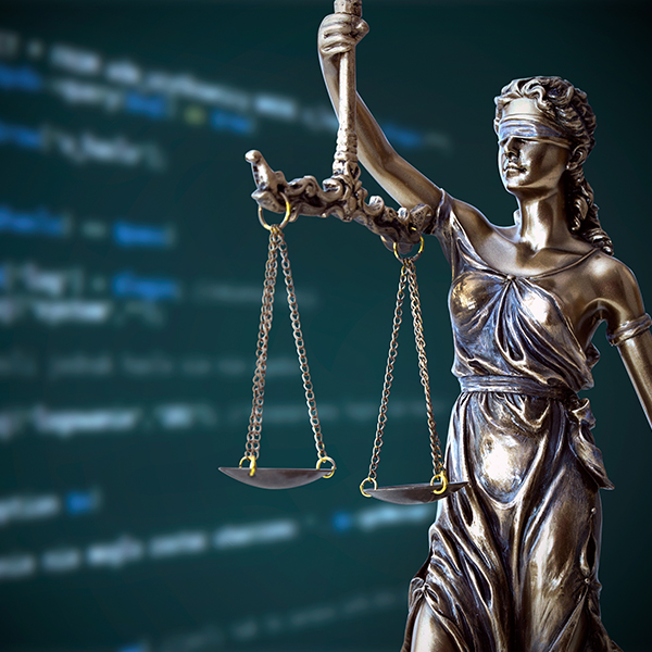 statue of justice with code behind