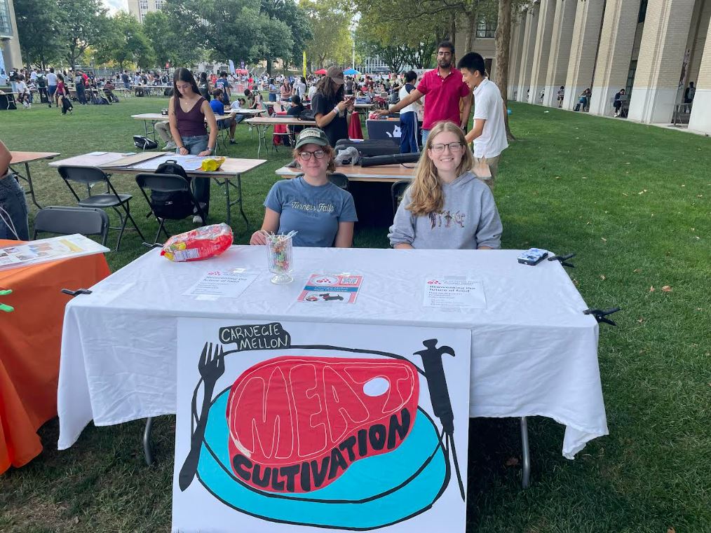picture of two students at a booth