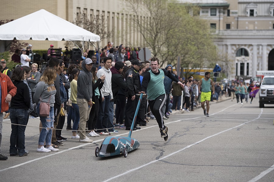 A photo of a man sprinting towards a buggy.