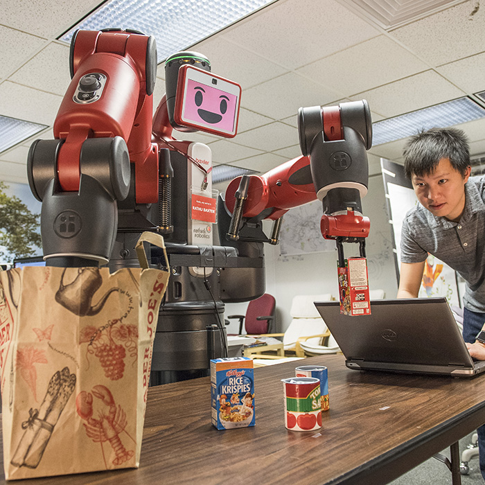 Robot operated by student bags groceries