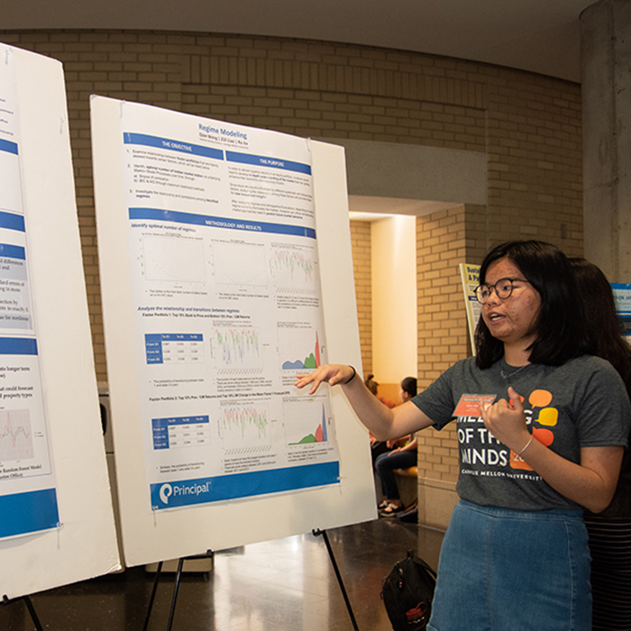 Woman presents data on poster boards