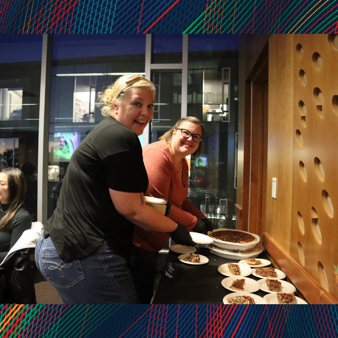 Two people cutting and serving pie