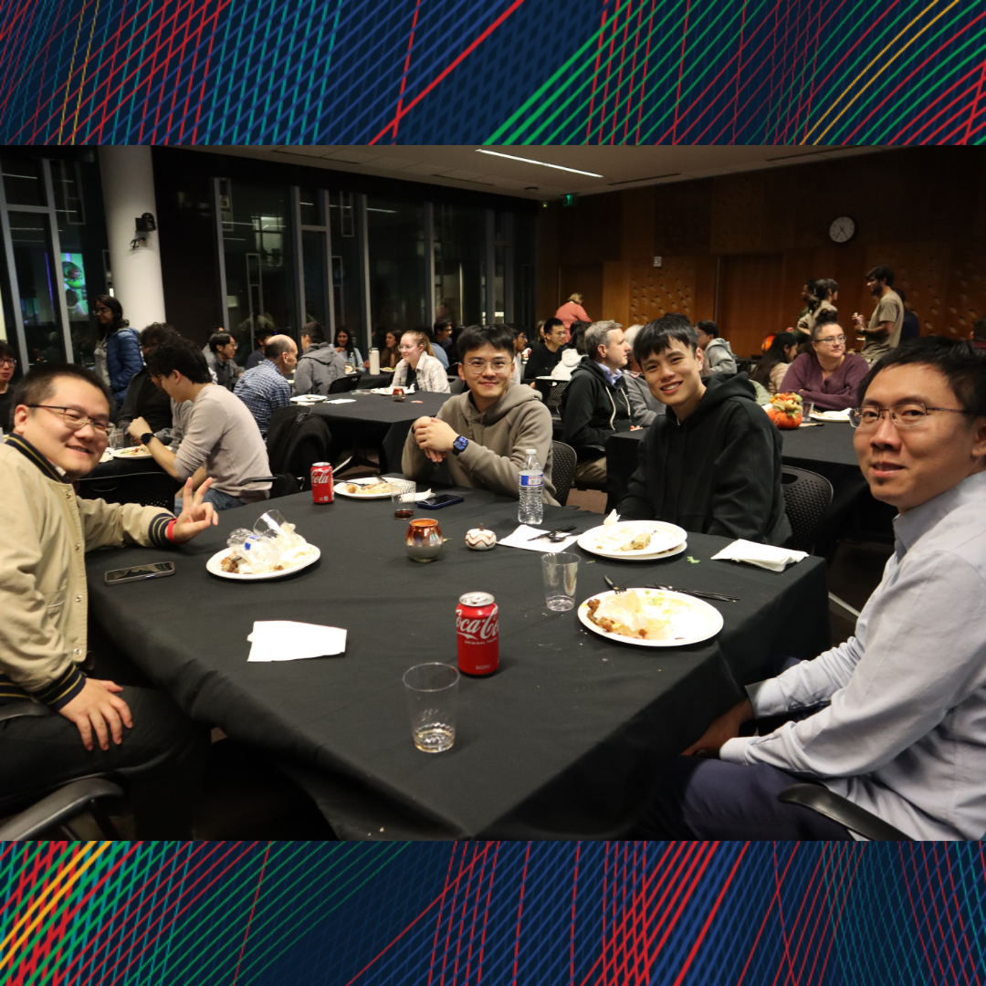 A group of people sitting at dinner and smiling at the camera