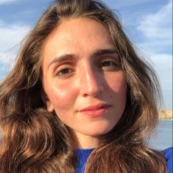 Woman with brown hair looking into the camera