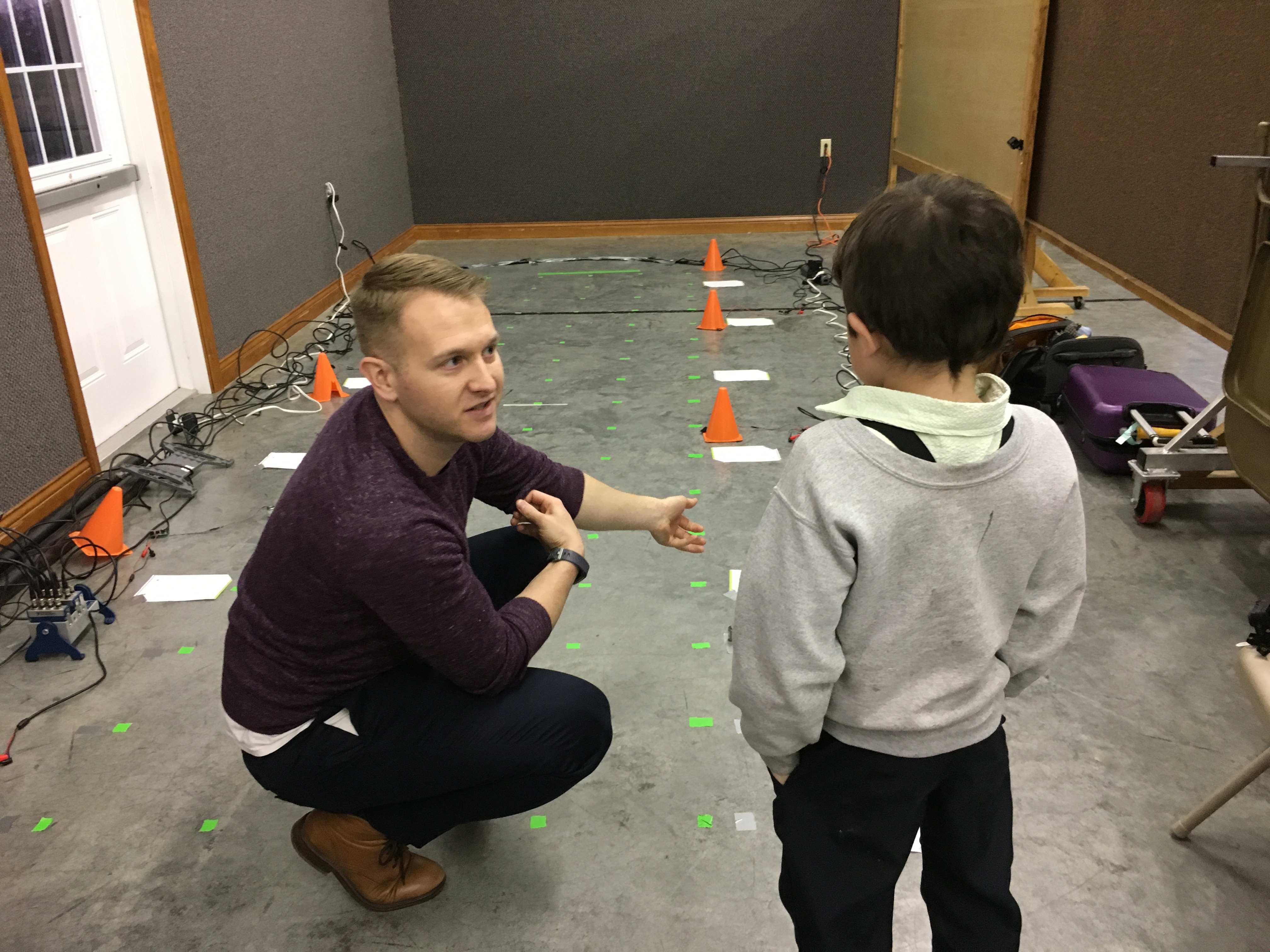 PhD student Jonathan Fagert works with young amish boy
