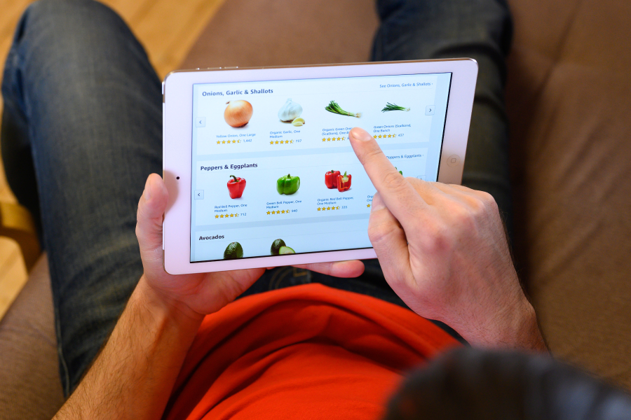 stock image of man ordering groceries on ipad