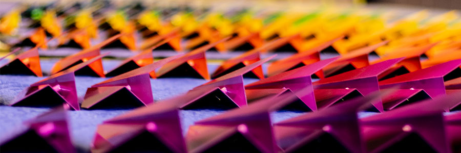 Photo of the rainbow colored planes in the sculpture Flight.