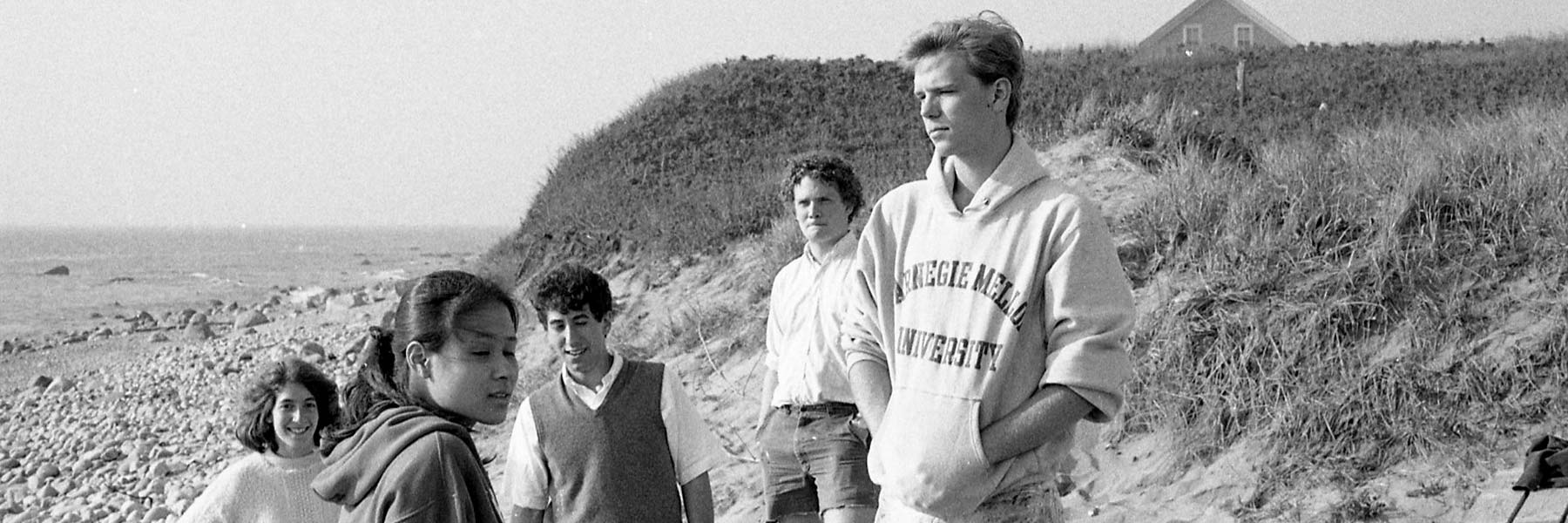 John Currin on the beach wearing a Carnegie Mellon University sweatshirt.