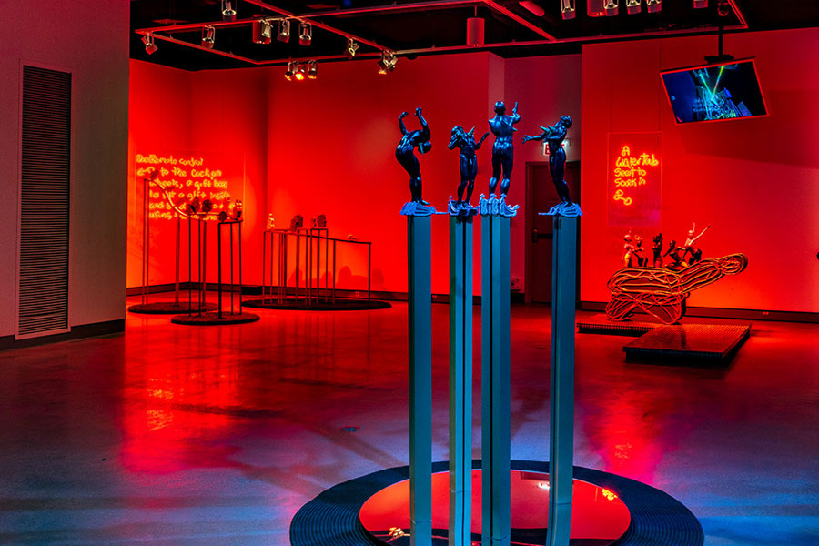 photo of three statues and a red background