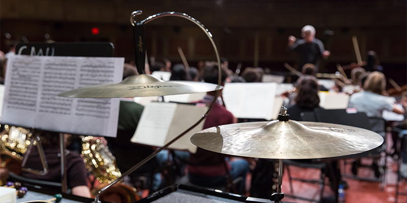 Cymbals and an orchestra in the background.