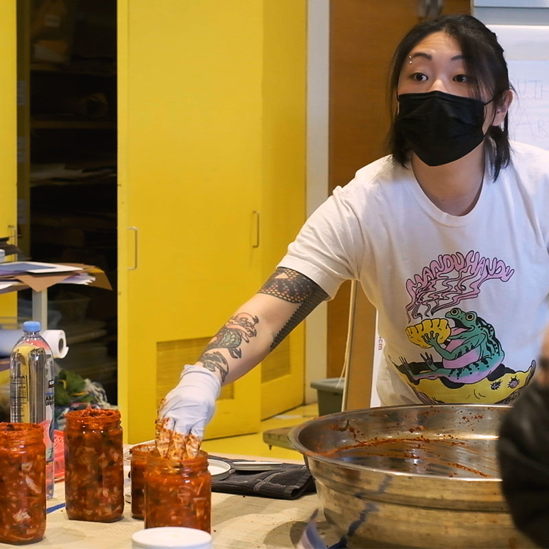 Person making food, wearing food safety gloves.