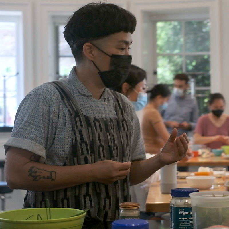 Person making food, wearing an apron.