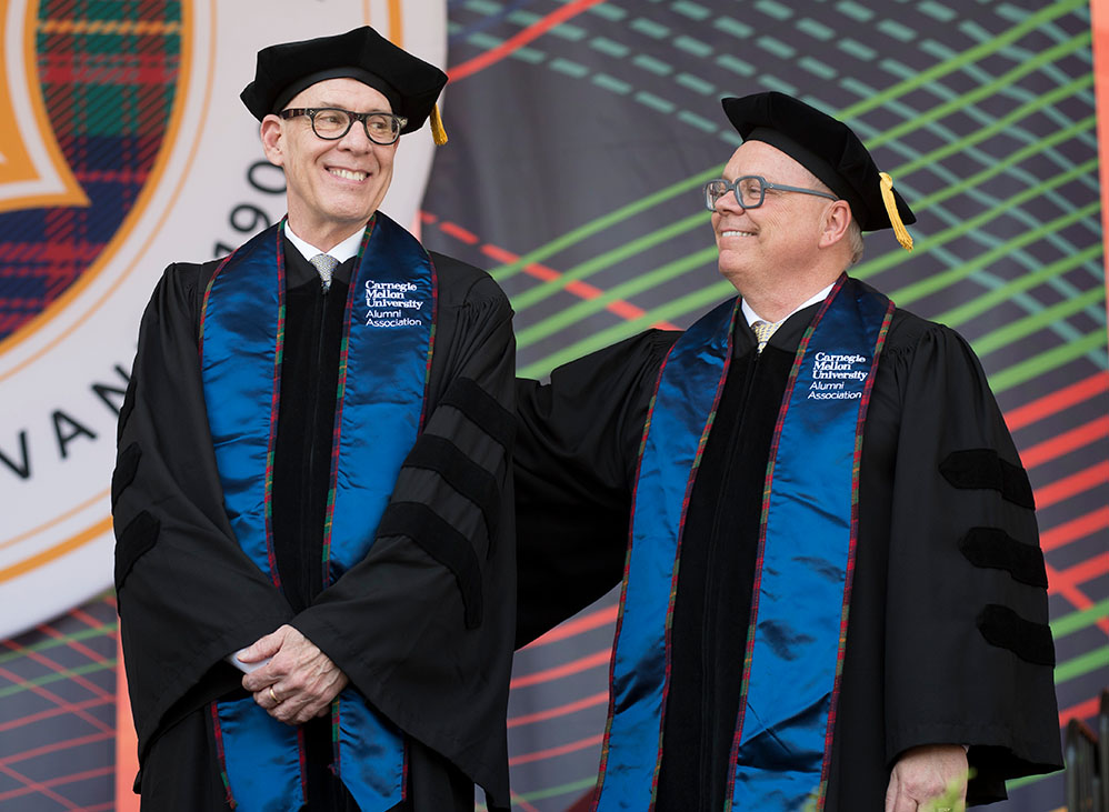 Joe and John, in full regalia, on stage at Commencement.