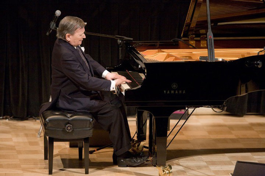 Byron Janis playing a grand piano.