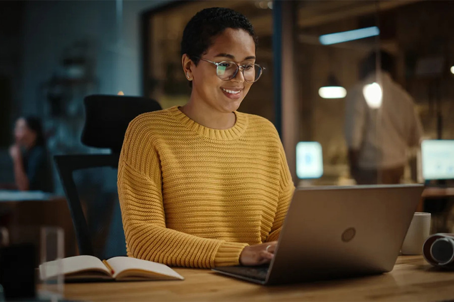 Woman working at a laptop.