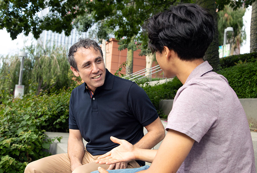 Samir talking to a young man.