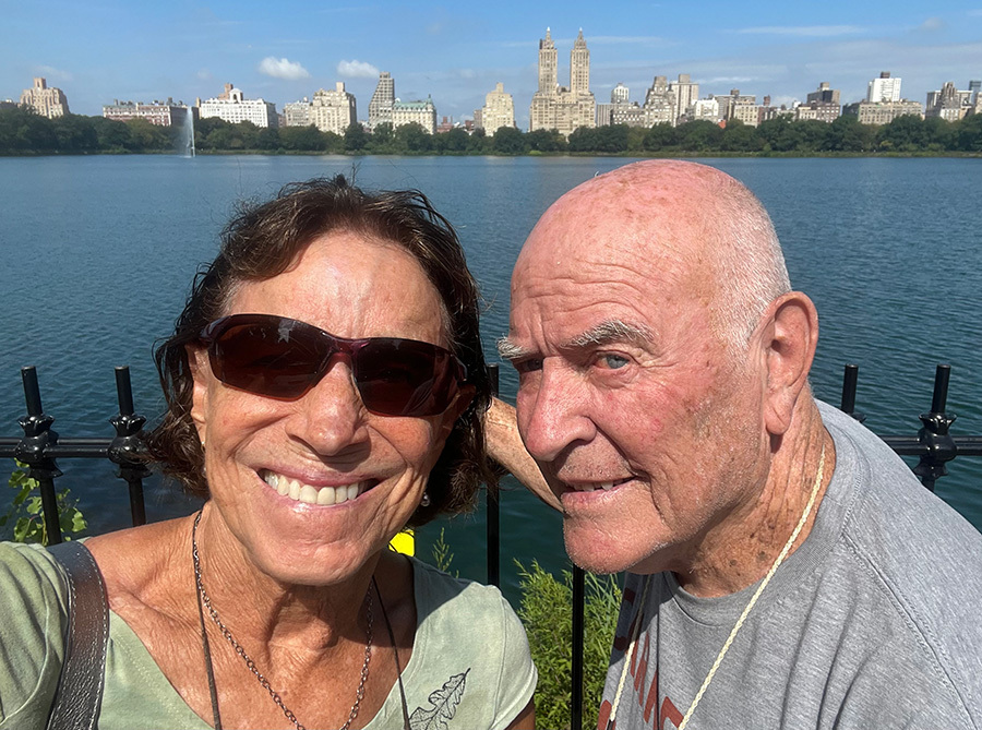 Francis and Erin Collins with a skyline in the background.