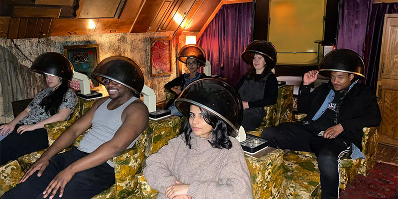 Photo of students in hair salon chairs.