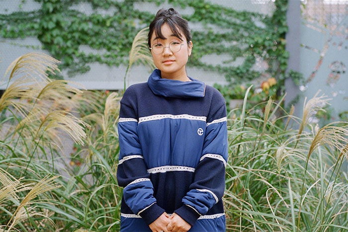 Photo of Kathy Lee standing in tall grass