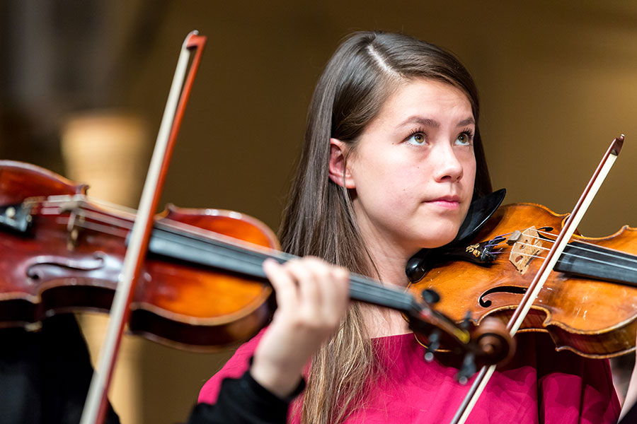 Violin student playing in an ensemble.