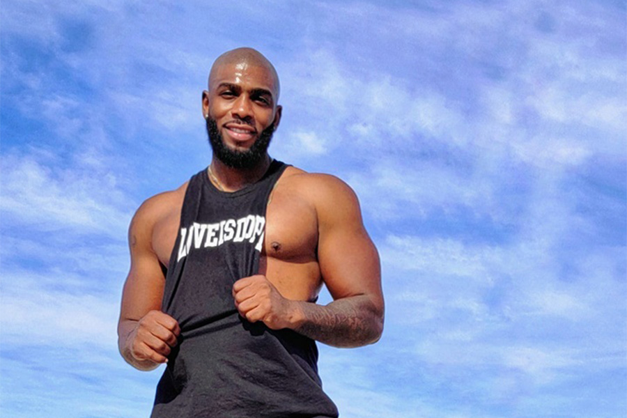 Photo of JT Houston on a beach with a perfectly blue sky.