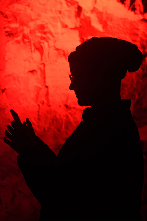 Photo of student's silhouette surrounded by orange-red light.