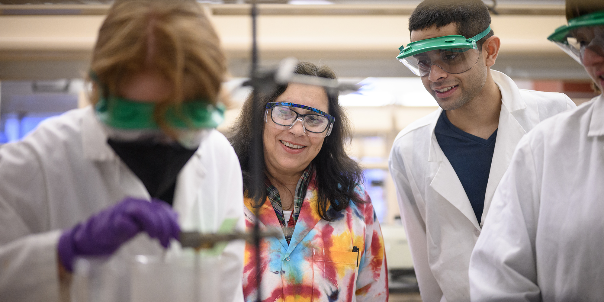 Faculty with students in lab setting
