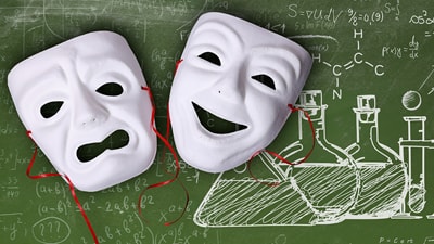 theater comedy/tragedy masks on chalkboard with chemical formulas and drawing of flasks
